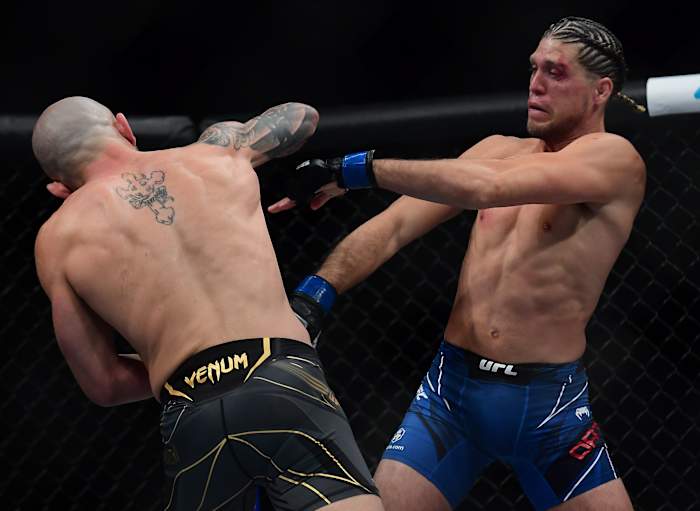 Brian Ortega defends against Alexander Volkanovski during UFC 266 at T-Mobile Arena.